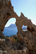 Kalymnos - the 'eye' in the arête towards sunset with the rock itself illuminated and the afternoon heat haze over the background