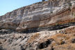Nisyros - the legacy of volcanic eruptions along the coast towards Lies is high pumice cliffs - the scale is shown by the line of geology enthuisiasts walking along the narrow path across the loose scree