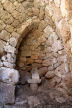 Nisyros -  the small simple chapel hidden at the back of one of the houses built into the rocks at the top of the mountain pass, showing the remains of the whitewashing around the entrance arch