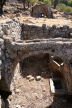 Nisyros - arch carrying water channel over small 'avli' or courtyard in front of a pair of semi-detached one room arched houses built under the terraced fields on the hillside