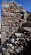 Nisyros - part of the now-being-restored Armas monastery showing typical form of construction using shards of terracotta to fill gaps between irregular stones and external flight of steps up to flat roof terrace