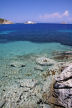 Symi - looking across the clear waters of Skoumisa Bay to the island monastery of Agios Emilianos