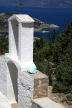 Symi - the bell-tower entrance to the small monastery of Agios Ioannis Theologos with Skoumisa Bay and Agios Eilianos far below