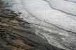 incoming tide over sand-covered wave-cut platform