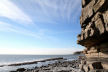 with one of the largest tidal ranges in the world, the sea comes in rapidly over the wave-cut platform right to the base of the cliff