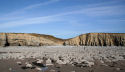 the dip in the cliffs gives access from the cliff-top path to the foreshore, and marks the begining of the caves which lie to the left (West) and none to the right (East) 