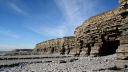 wave-cut platform backed by cliffs and sea-caves