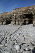sea-caves in cliffs backing extensice wave-cut platform