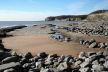 outgoing tide reveals stretches of sand beyond the rocky foreshore - sometimes smooth