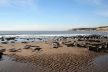 outgoing tide reveals stretches of sand beyond the rocky foreshore - sometimes rippled